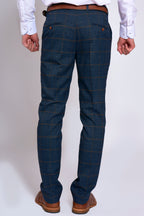 Man wearing men's JENSON - Marine Navy Check Trousers - Marc Darcy Menswear